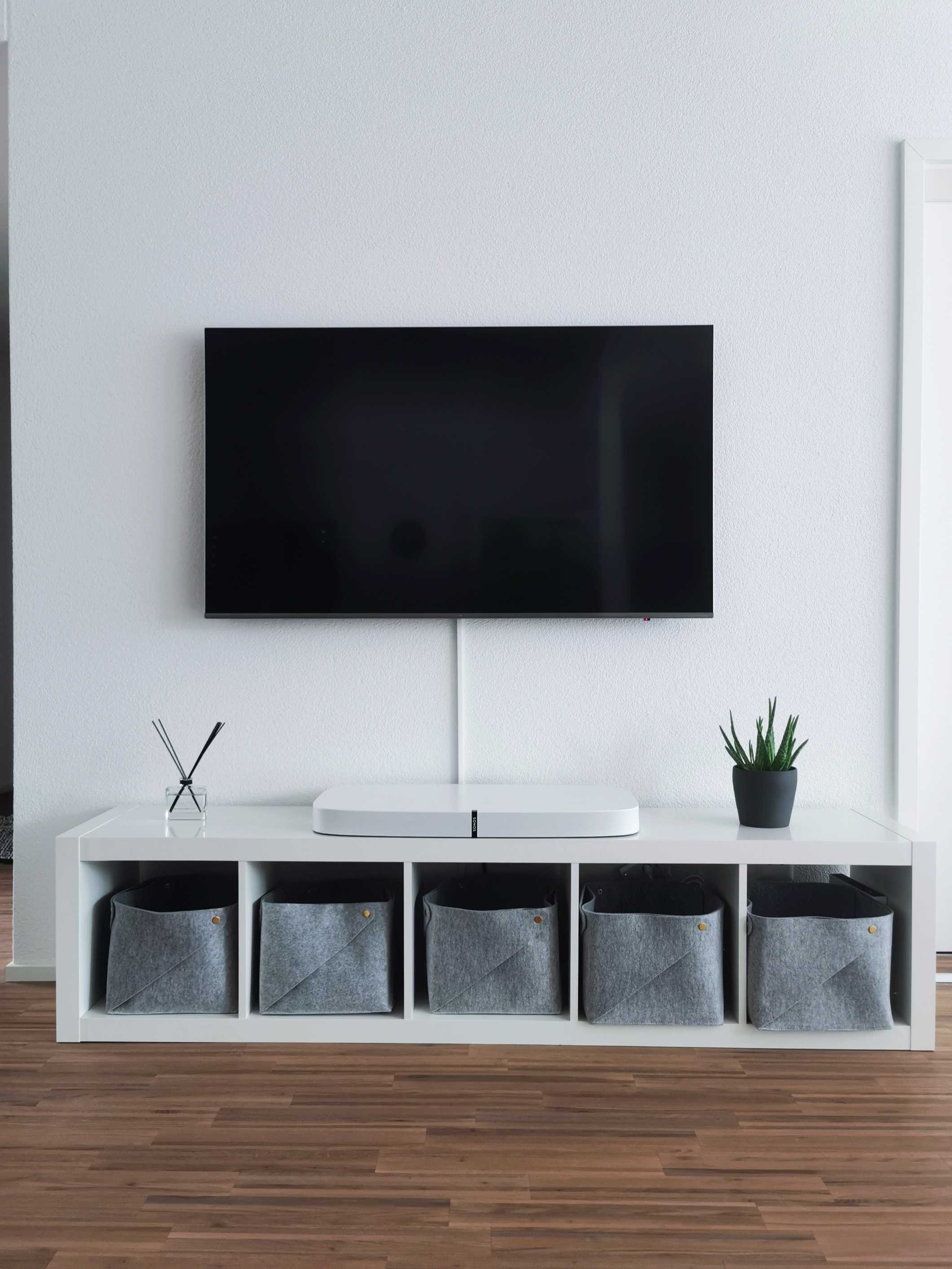 Tv mounted deals above tv stand